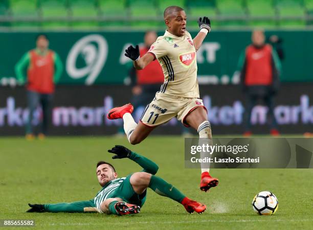 Endre Botka of Ferencvarosi TC slide tackles Loic Nego of Videoton FC during the Hungarian OTP Bank Liga match between Ferencvarosi TC and Videoton...