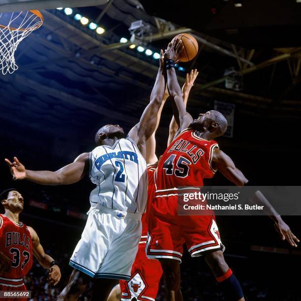 Larry Johnson of the Charlotte Hornets battles for a rebound against Michael Jordan of the Chicago Bulls in Game Two of the Eastern Conference...