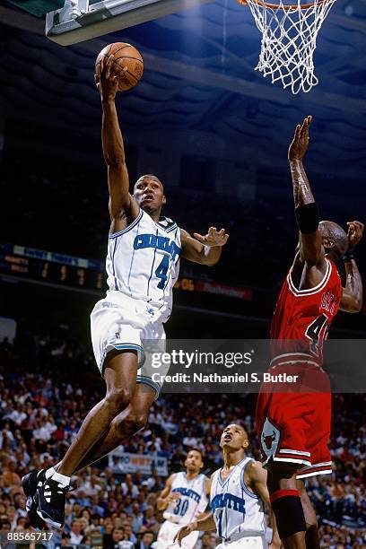 Darrin Hancock of the Charlotte Hornets drives to the basket for a layup against Michael Jordan of the Chicago Bulls in Game Two of the Eastern...