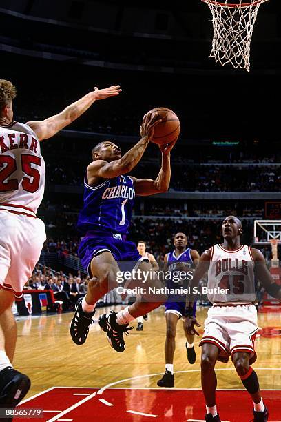 Muggsy Bogues of the Charlotte Hornets goes up for a shot against the Chicago Bulls in Game Three of the Eastern Conference Quarterfinals during the...