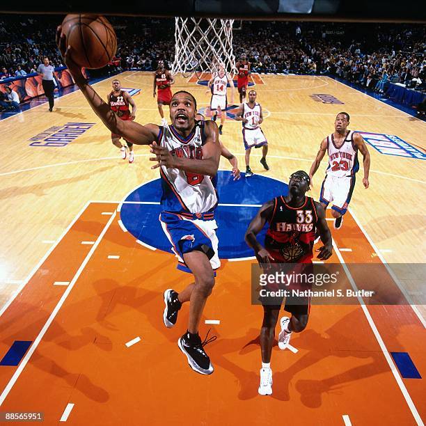 Latrell Sprewell of the New York Knicks shoots a layup against Tyrone Corbin of the Atlanta Hawks in Game Three of the Eastern Conference Semifinals...