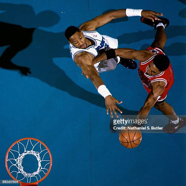 Scottie Pippen of the Chicago Bulls shoots a layup against Alonzo Mourning of the Charlotte Hornets in Game One of the Eastern Conference...