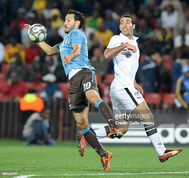 Gianluca Zambrotta of Italy and Mohamed Aboutrika of Egypt battle during the 2009 Confederations Cup match between Egypt and Italy at Coca-Cola...