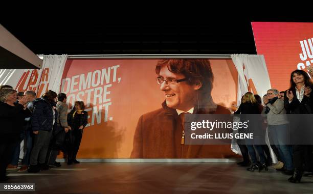 An electoral billboard with the image of 'Junts per Catalonia' grouping cadidate for the upcoming Catalan regional election, Carles Puigdemont, is...