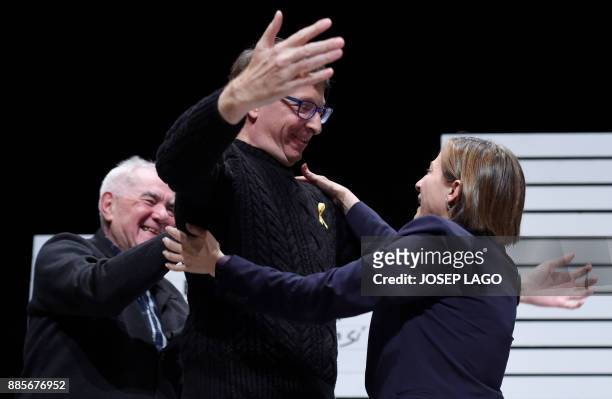 Former president of the Catalan parliament Carme Forcadell hugs deposed Catalan regional government justice chief, Carles Mundo during the campaign...