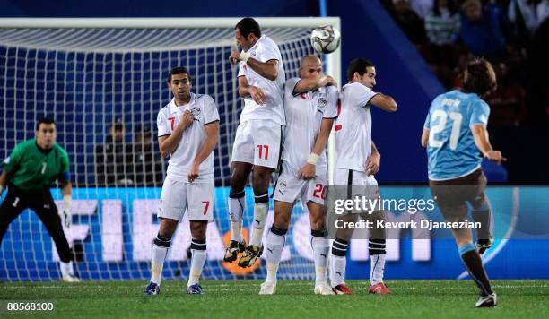 Andrea Pirlo of Italy hits a free kick over the wall defended by Ahmed Fathi, Mohamed Shawky, Wael Gomaa, and Mohamed Aboutrika of Egypt during the...