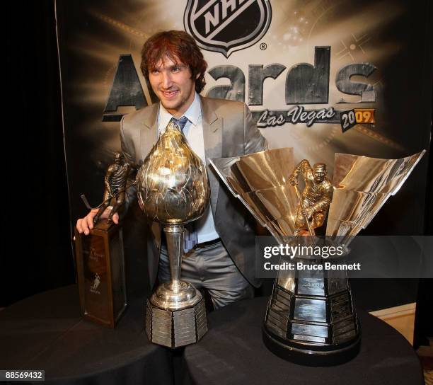 Alexander Ovechkin of the Washington Capitals poses with the Lester B. Pearson Award, the Hart Trophy and the Maurice Richard Trophy following the...