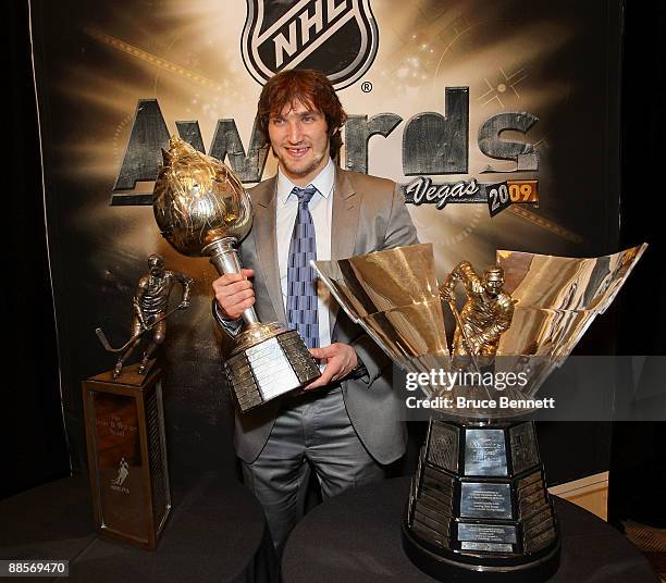 Alexander Ovechkin of the Washington Capitals poses with the Lester B. Pearson Award, the Hart Trophy and the Maurice Richard Trophy following the...