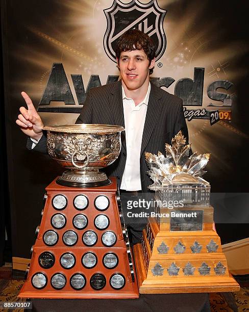 Evgeni Malkin of the Pittsburgh Penguins poses with the Art Ross Trophy and the Conn Smythe Trophy following the 2009 NHL Awards at the Palms Casino...