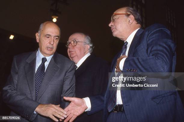Politician Bettino Craxi shakes hand of Giorgio Napolitano, Giovanni Spadolini is also present, Rome 1989.
