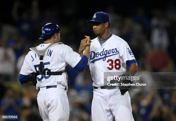 Pitcher Ramon Troncoso and catcher Russell Martin of the Los Angeles Dodgers celebrate after the game with the Oakland Athletics on June 18, 2009 at...