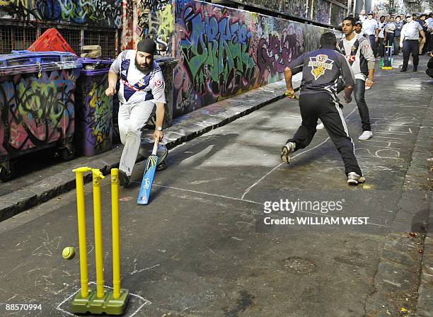 Indian students take on police officers in a game of laneway cricket in Melbourne on June 19, 2009 to promote a message of harmony following a spate...