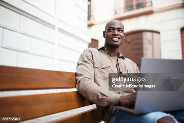 african man using laptop. - 2017 common good forum stock pictures, royalty-free photos & images