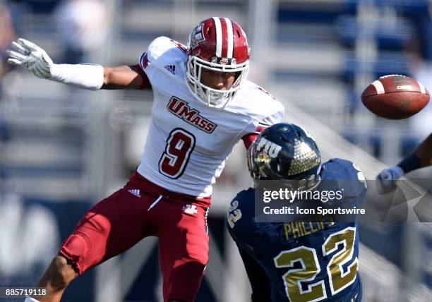 UMass defensive back Isaiah Rodgers takes the ball away from Florida International University running back Shawndarrius Phillips during an NCAA...
