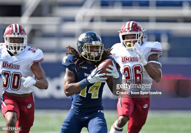Florida International University wide receiver Darrius Scott catches a pass during an NCAA football game between the University of Massachusetts...