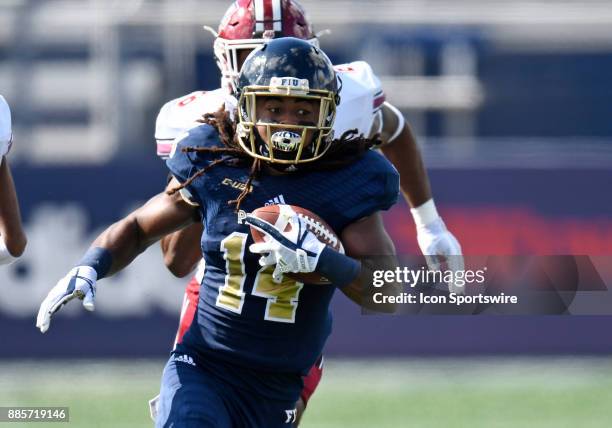 Florida International University wide receiver Darrius Scott plays during an NCAA football game between the University of Massachusetts Minutemen and...