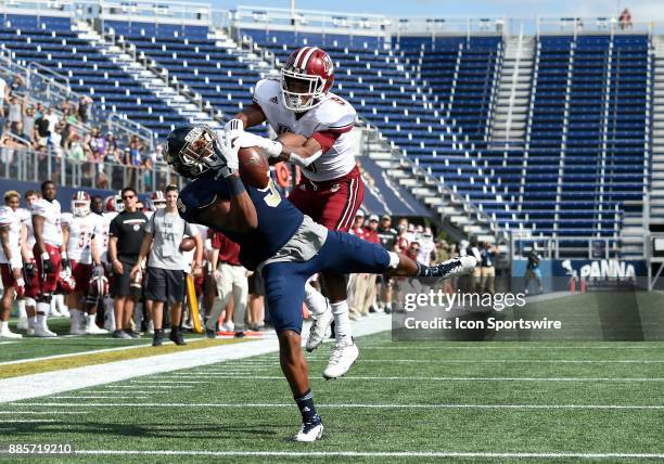 Florida International University wide receiver Bryce Singleton catches a touchdown pass against UMass defensive back Isaiah Rodgers during an NCAA...