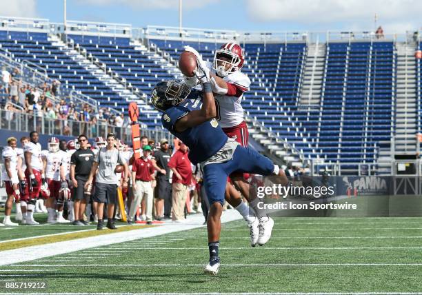 Florida International University wide receiver Bryce Singleton catches a touchdown pass against UMass defensive back Isaiah Rodgers during an NCAA...