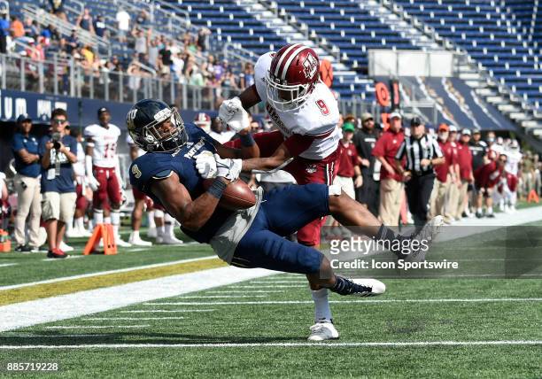 Florida International University wide receiver Bryce Singleton catches a touchdown pass against UMass defensive back Isaiah Rodgers during an NCAA...