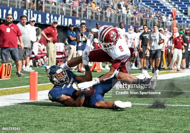 Florida International University wide receiver Bryce Singleton catches a touchdown pass against UMass defensive back Isaiah Rodgers during an NCAA...
