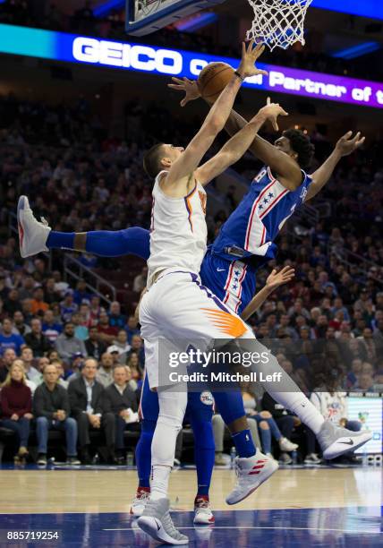 Joel Embiid of the Philadelphia 76ers blocks the shot of Alex Len of the Phoenix Suns in the first quarter at the Wells Fargo Center on December 4,...