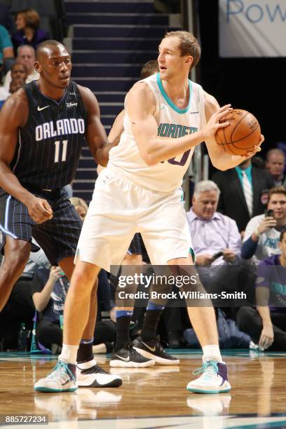 Cody Zeller of the Charlotte Hornets looks to pass the ball against the Orlando Magic on December 4, 2017 at Spectrum Center in Charlotte, North...