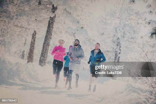 runners on snow covered mountain - running in deep snow stock pictures, royalty-free photos & images