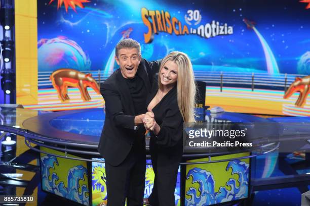 Michelle Hunziker jokes with Ezio Greggio during the photocall with the photographers, in the studio of Striscia in Canale 5.