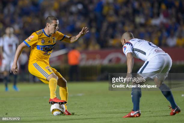Jesus Duenas of Tigres fights for the ball with Miguel Samudio of America during the semifinal second leg match between Tigres UANL and America as...