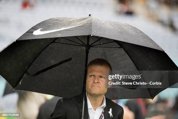 Josep Gombau of the Wanderers watches his team warm up under an umbrella during the round nine A-League match between the Western Sydney Wanderers...
