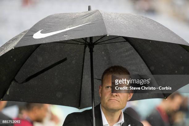 Josep Gombau of the Wanderers watches his team warm up under an umbrella during the round nine A-League match between the Western Sydney Wanderers...