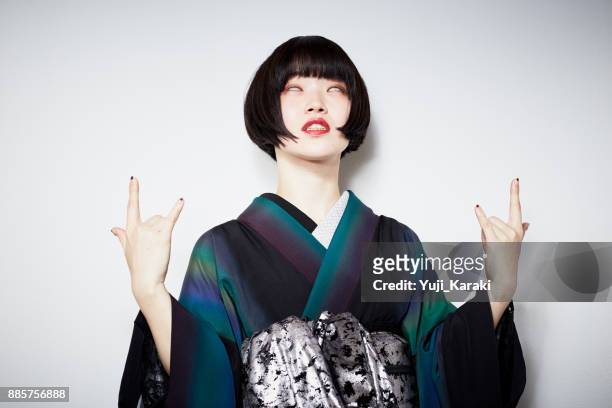a modern girl in a kimono - kimono stock pictures, royalty-free photos & images