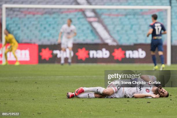 Alvaro Cejudo of the Wanderers lies on the ground after being heavily tackled during the round nine A-League match between the Western Sydney...