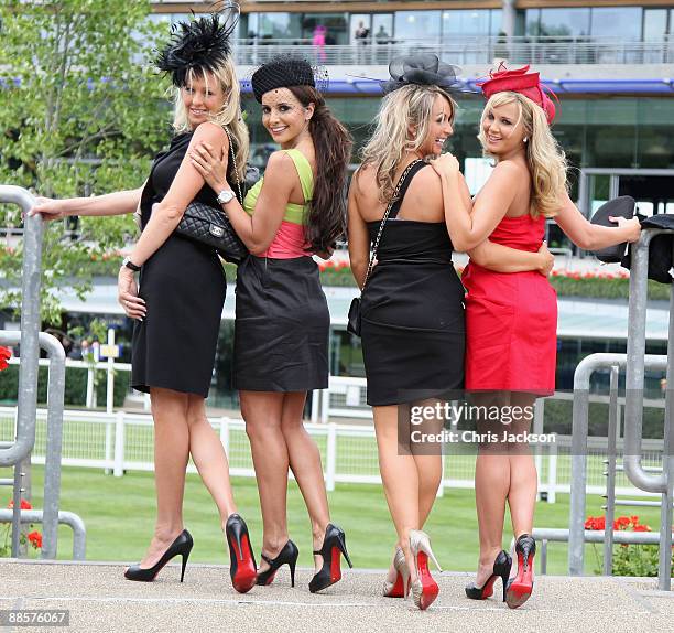 Girls with red soled high heeled shoes pose for a photograph on the second day of Royal Ascot 2009 at Ascot Racecourse on June 19, 2009 in Ascot,...