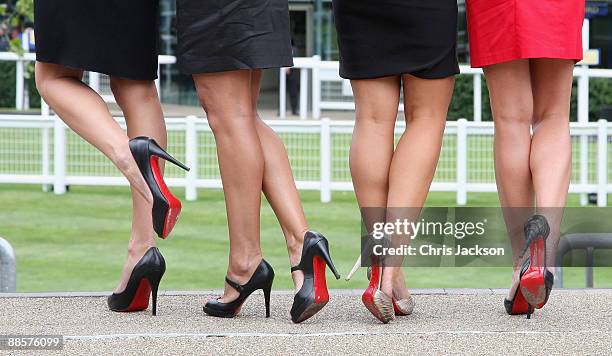 Girls with red soled high heeled shoes pose for a photograph on the second day of Royal Ascot 2009 at Ascot Racecourse on June 19, 2009 in Ascot,...