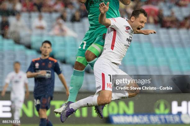 Brendon Santalab of the Wanderers is hurt in this challenge by Roar's goalkeeper Jamie Young during the round nine A-League match between the Western...