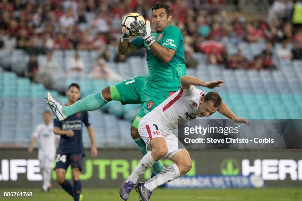 Brendon Santalab of the Wanderers is hurt in this challenge by Roar's goalkeeper Jamie Young during the round nine A-League match between the Western...