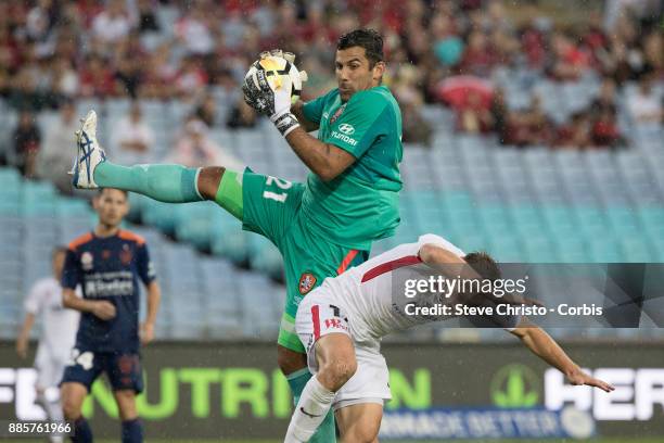 Brendon Santalab of the Wanderers is hurt in this challenge by Roar's goalkeeper Jamie Young during the round nine A-League match between the Western...