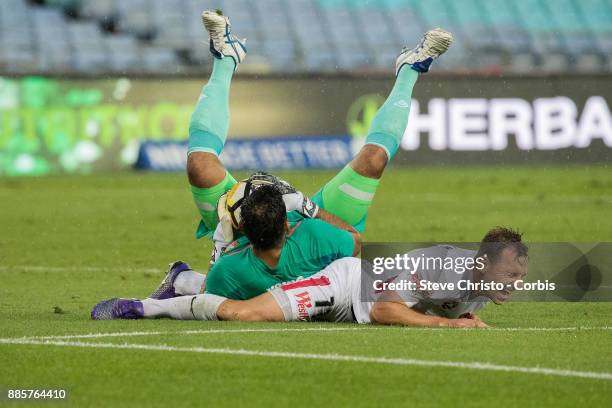 Brendon Santalab of the Wanderers is hurt in this challenge by Roar's goalkeeper Jamie Young during the round nine A-League match between the Western...