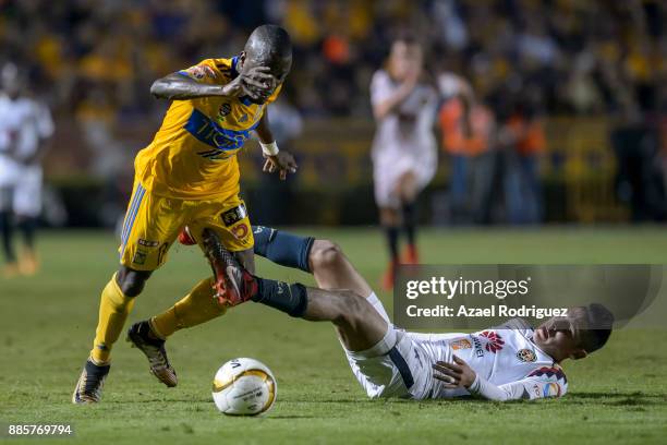 Enner Valencia of Tigres fights for the ball with Edson Alvarez of America during the semifinal second leg match between Tigres UANL and America as...