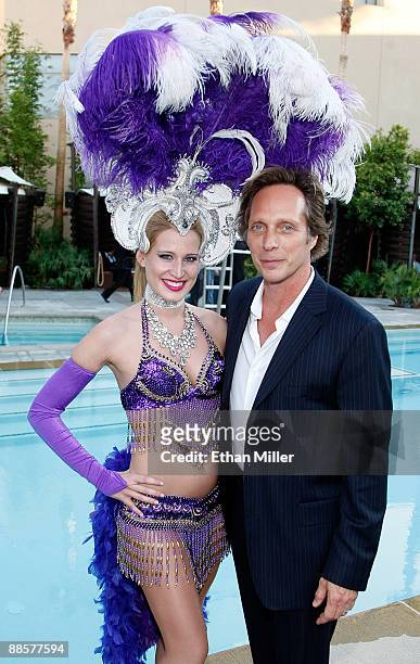 Actor William Fichtner poses with a showgirl at the 2009 NHL Awards after party at The Palms Casino Resort on June 18, 2009 in Las Vegas, Nevada.