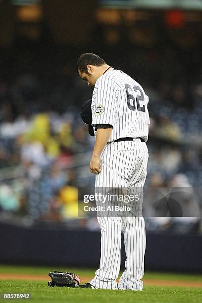 Joba Chamberlain of The New York Yankees prays before pitching against The Washington Nationals during their game on June 18th, 2009 at Yankee...