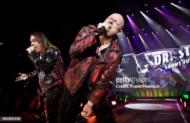 Andi Deris and Michael Kiske of the German band Helloween perform live on stage during a concert at the Tempodrom on December 4, 2017 in Berlin,...