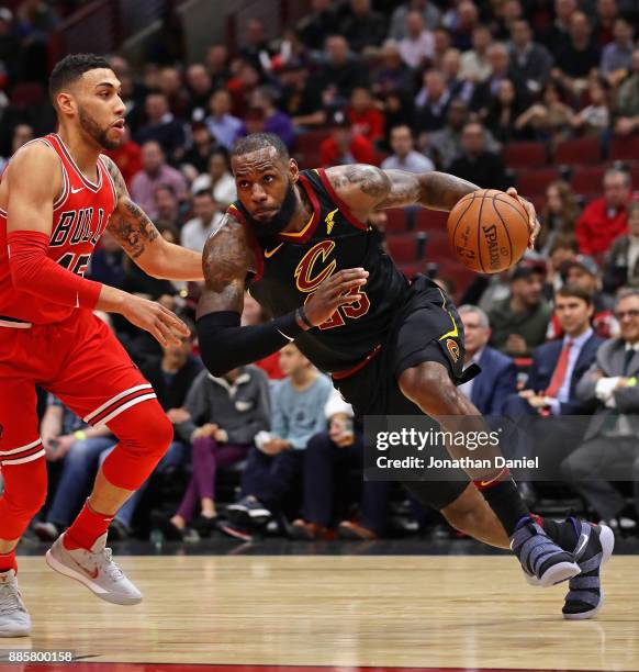 LeBron James of the Cleveland Cavaliers drives against Denzel Valentine of the Chicago Bulls at the United Center on December 4, 2017 in Chicago,...