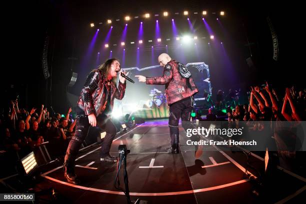 Andi Deris and Michael Kiske of the German band Helloween perform live on stage during a concert at the Tempodrom on December 4, 2017 in Berlin,...