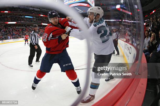 Alex Chiasson of the Washington Capitals and Barclay Goodrow of the San Jose Sharks fight during the third period at Capital One Arena on December 4,...