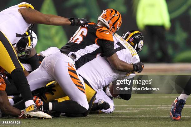 Carlos Dunlap of the Cincinnati Bengals sacks Ben Roethlisberger of the Pittsburgh Steelers during the first half at Paul Brown Stadium on December...