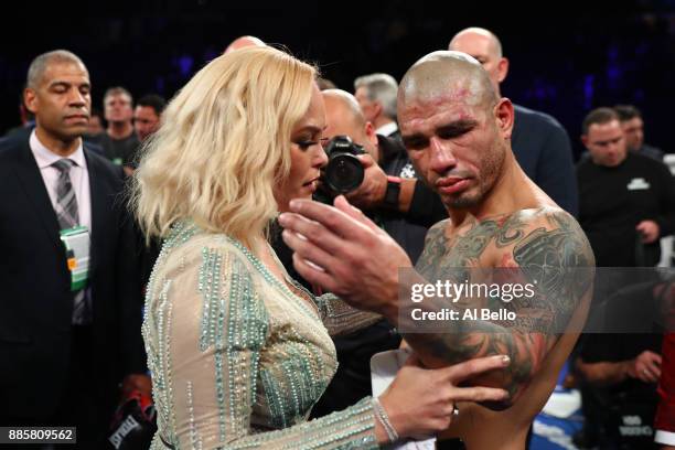 Miguel Cotto shows his wife Melissa Guzman his torn bicep after losing his last Junior Middleweight bout against Sadaam Ali at Madison Square Garden...