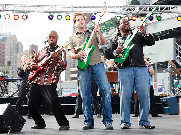 Earth Wind & Fire's Greg Moore, Chicago's Keith Howland and Earth Wind & Fire's Morris O'Connor perform on CBS' "The Early Show" on the USS Intrepid...