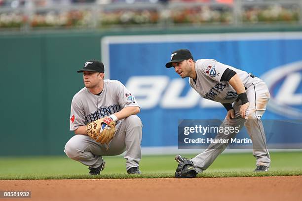 Second baseman Aaron Hill and shortstop Marco Scutaro of the Toronto Blue Jays take a break during a pitching change during a game against the...